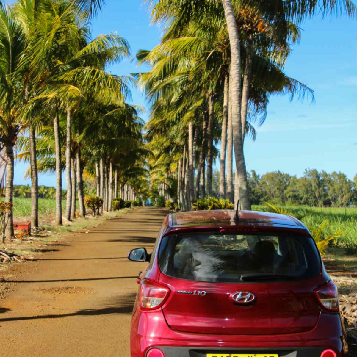 Dodrives red i10 on beach road in Mauritius