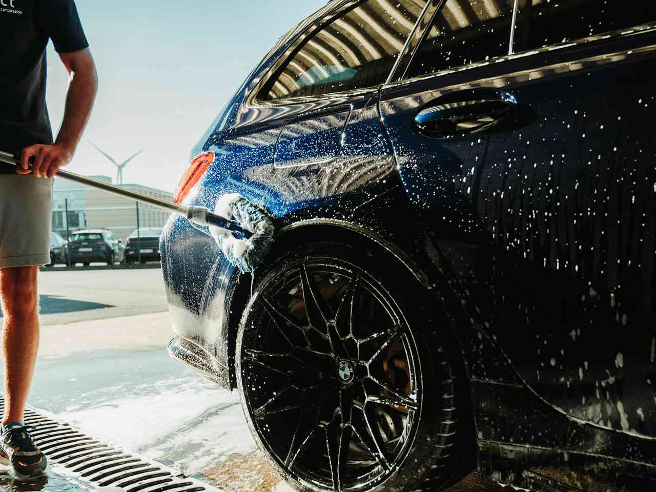 Man washing a Dodrives car thoroughly.